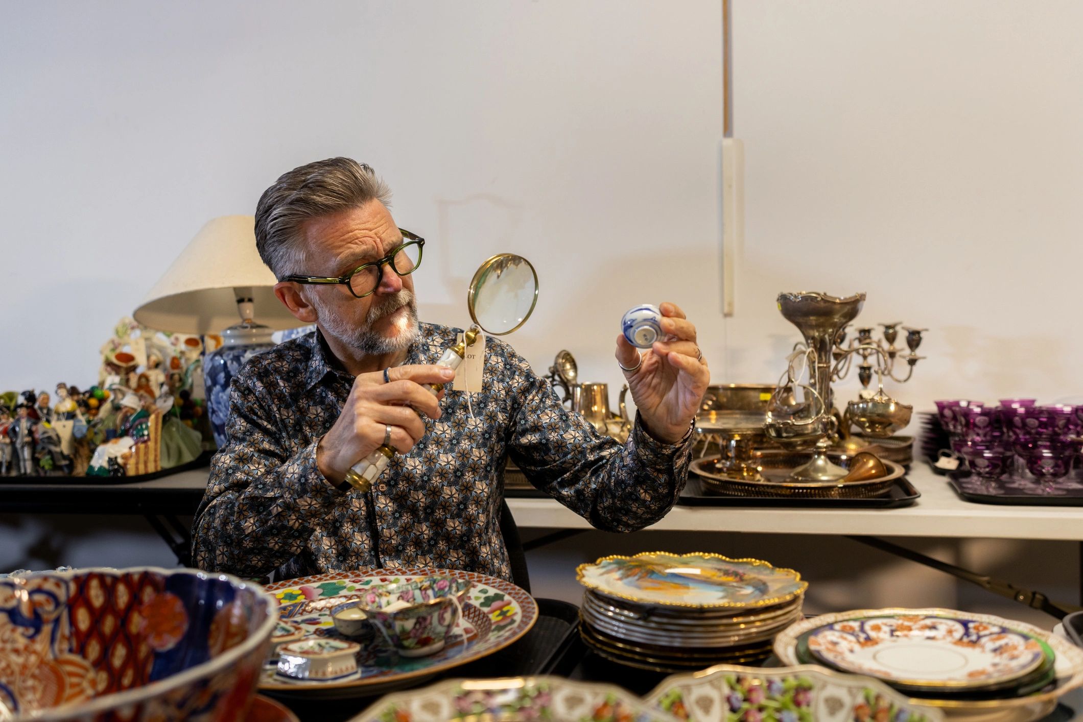 Expert appraiser examining antique lamp